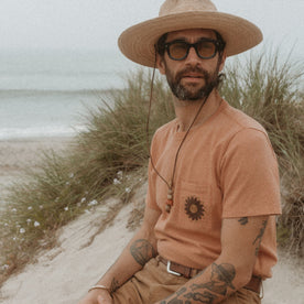 fit model on the beach in The Embroidered Heavy Bag Tee in Dried Acorn Aubade, Knits by Taylor Stitch