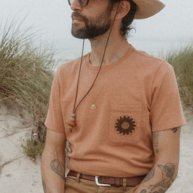 fit model sitting in The Embroidered Heavy Bag Tee in Dried Acorn Aubade, Knits by Taylor Stitch