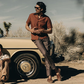 fit model leaning against a car wearing The Palmer Shirt in Dried Guajillo, Wovens by Taylor Stitch