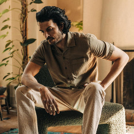 fit model sitting in The Short Sleeve Hawthorne in Sea Moss, Wovens by Taylor Stitch