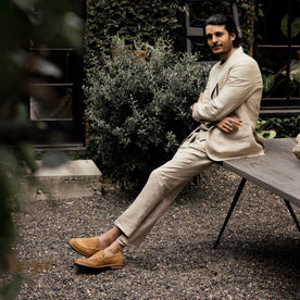 fit model sitting wearing The Loafer in Tan Suede, Footwear by Taylor Stitch