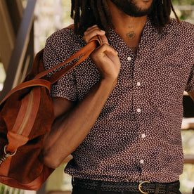 fit model holding a bag wearing The Short Sleeve Hawthorne in Port Shell, Wovens by Taylor Stitch