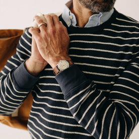 fit model holding a bag over his shoulder wearing The Adams Crew in Dark Navy Stripe Reverse Terry, Knits by Taylor Stitch