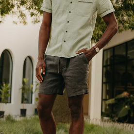 fit model with his hand in his pocket wearing The Apres Short in Faded Black Hemp, Bottoms by Taylor Stitch