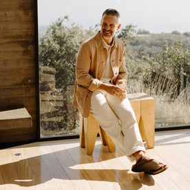 fit model sitting wearing The Ojai Jacket in Chili Stripe Linen, Outerwear by Taylor Stitch