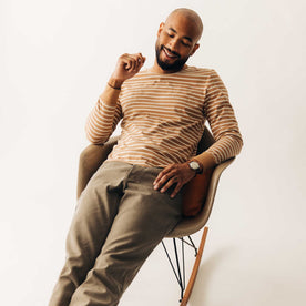 fit model sitting wearing The Organic Cotton Long Sleeve Tee in Churro Stripe, Knits by Taylor Stitch