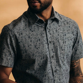 fit model showing off the buttons on The Short Sleeve California in Blue Chambray Botanical, Wovens by Taylor Stitch