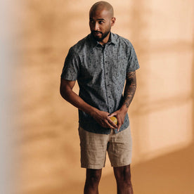 fit model standing wearing The Short Sleeve California in Blue Chambray Botanical, Wovens by Taylor Stitch