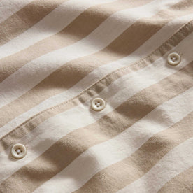 material shot of the buttons on The Short Sleeve Davis Shirt in Sandbar Stripe, Wovens by Taylor Stitch