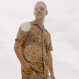 fit model posing wearing The Short Sleeve Davis Shirt in Tarnished Gold Print, Wovens by Taylor Stitch