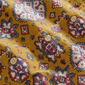 material shot of the buttons on The Short Sleeve Davis Shirt in Tarnished Gold Print, Wovens by Taylor Stitch