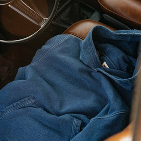 editorial image of The Apres Hoodie in Washed Indigo Terry in a car, Knits by Taylor Stitch