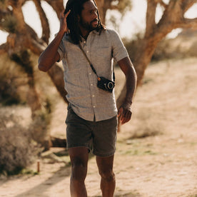 fit model walking wearing The Camp Short in Coal Chipped Canvas, Bottoms by Taylor Stitch