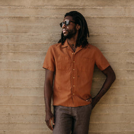 fit model leaning against the wall wearing The Conrad Shirt in Adobe Embroidery, Wovens by Taylor Stitch