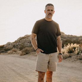 fit model with his hand in his pocket wearing The Cotton Hemp Tee in Charcoal, Knits by Taylor Stitch