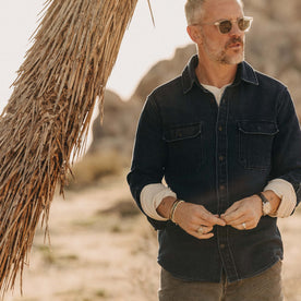 fit model standing by a tree wearing The Division Shirt in Indigo Twill, Wovens by Taylor Stitch