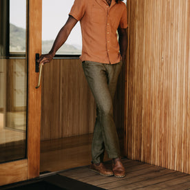 fit model leaning against the wall wearing The Easy Pant in Olive Linen, Bottoms by Taylor Stitch