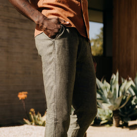 fit model with his hand in his pocket wearing The Easy Pant in Olive Linen, Bottoms by Taylor Stitch