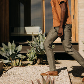 fit model walking on gravel wearing The Easy Pant in Olive Linen, Bottoms by Taylor Stitch