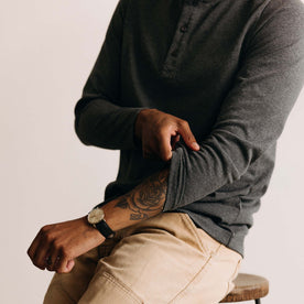 fit model adjusting the sleeves on The Heavy Bag Henley in Heather Grey, Knits by Taylor Stitch