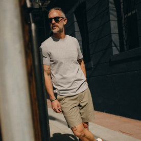 fit model leaning against the wall wearing The Heavy Bag Tee in Aluminum, Knits by Taylor Stitch