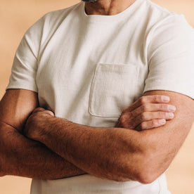 fit model with his arms crossed wearing The Heavy Bag Tee in Natural, Knits by Taylor Stitch