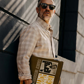 fit model holding records wearing The Jack in Heather Flax Plaid, Wovens by Taylor Stitch