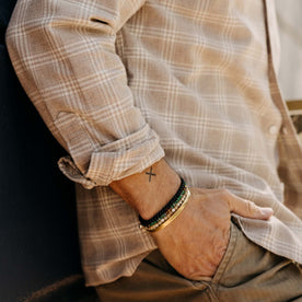 fit model with his hand in his pocket wearing The Jack in Heather Flax Plaid, Wovens by Taylor Stitch