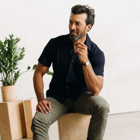 fit model sitting wearing The Short Sleeve California in Rinsed Indigo Slub, Wovens by Taylor Stitch