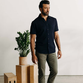 fit model standing wearing The Short Sleeve California in Rinsed Indigo Slub, Wovens by Taylor Stitch