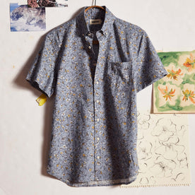 editorial image of The Short Sleeve Jack in Light Blue Floral in front of drawings, Wovens by Taylor Stitch