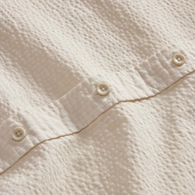 material shot of the buttons on The Short Sleeve Jack in Natural Seersucker, Wovens by Taylor Stitch