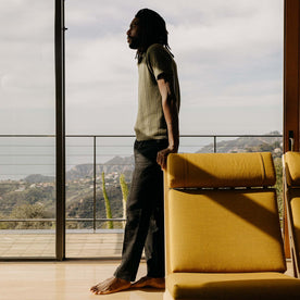 fit model leaning on a chair wearing The Valencia Sweater Polo in Cilantro Rib, Knits by Taylor Stitch