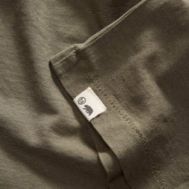 material shot of the hem with the TS label on The Cotton Hemp Tee in Olive, Knits by Taylor Stitch