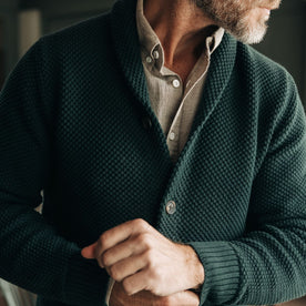 fit model adjusting cuffs on The Crawford Sweater in Dark Forest, Knits by Taylor Stitch