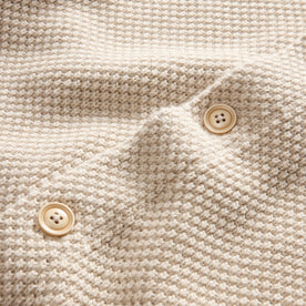 material shot of the buttons on The Crawford Sweater in Marled Natural, Knits by Taylor Stitch