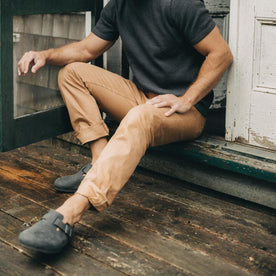 fit model sitting wearing The Democratic All Day Pant in Tobacco Selvage Denim, Bottoms by Taylor Stitch