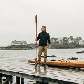 fit model on a dock in the Quarter Zip Tanker Sweater in Loden, Knits by Taylor Stitch