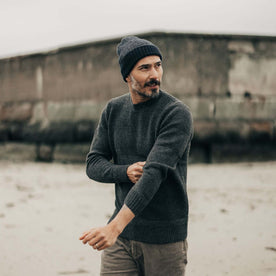 fit model adjusting his sleeves in The Headland Beanie in Dark Navy, Accessories by Taylor Stitch