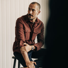 fit model sitting in The Maritime Shirt Jacket in Black Cherry Moleskin, Wovens by Taylor Stitch