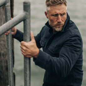 fit model going down a ladder in The Maritime Shirt Jacket in Dark Navy Moleskin, Wovens by Taylor Stitch