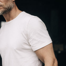 fit model showing off sleeves on The Organic Cotton Tee in Vintage White, Knits by Taylor Stitch