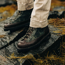 fit model standing on a rock wearing The Ridge Boot in Painted Camo, Footwear by Taylor Stitch