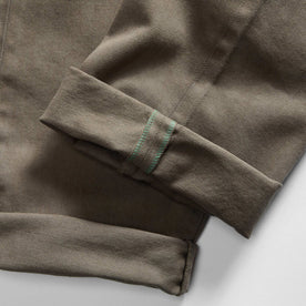 material shot of the selvage cuffs on The Slim All Day Pant in Fatigue Olive Selvage Denim, Bottoms by Taylor Stitch