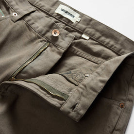 material shot of the waistband on The Slim All Day Pant in Fatigue Olive Selvage Denim, Bottoms by Taylor Stitch