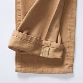 material shot of the selvage cuffs on The Slim All Day Pant in Tobacco Selvage Denim, Bottoms by Taylor Stitch