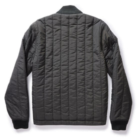 flatlay of The Able Jacket in Faded Black Quilted Nylon, shown from the back, Outerwear by Taylor Stitch