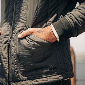 fit model with his hands in the pockets of The Able Jacket in Faded Black Quilted Nylon, Outerwear by Taylor Stitch