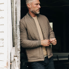 fit model adjusting his sleeves in The Able Jacket in Morel Quilted Nylon, Outerwear by Taylor Stitch