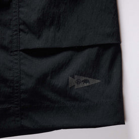 material shot of the tag on The Challenge Cargo Short in Black, Bottoms by Taylor Stitch